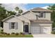 Charming two-story home featuring stucco exterior, shutters and a well-manicured lawn at 5179 Firebush Dr, Apopka, FL 32712