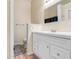 Bathroom features a white vanity with double sinks, large mirror, toilet and wood-look flooring at 545 W Cummings St, Lake Alfred, FL 33850