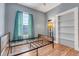 Bedroom with hardwood floors, blue walls, and built in shelving at 545 W Cummings St, Lake Alfred, FL 33850