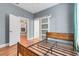 Bedroom with hardwood floors, sliding door closet, and view to other room at 545 W Cummings St, Lake Alfred, FL 33850