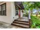 Inviting front porch with awning and lush greenery framing the entrance at 545 W Cummings St, Lake Alfred, FL 33850