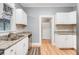 View of kitchen featuring granite countertops, tile backsplash, stainless appliances, and hardwood floors at 545 W Cummings St, Lake Alfred, FL 33850