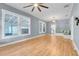 Spacious living room boasting hardwood floors, large windows, and a cozy built-in bench at 545 W Cummings St, Lake Alfred, FL 33850