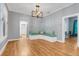Open living room featuring hardwood floors, a built-in bench, and a contemporary light fixture at 545 W Cummings St, Lake Alfred, FL 33850