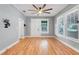 Light-filled living room with hardwood floors, neutral paint, and a ceiling fan at 545 W Cummings St, Lake Alfred, FL 33850