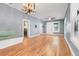 Bright living room with hardwood floors, a built-in bench, and modern light fixture at 545 W Cummings St, Lake Alfred, FL 33850