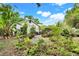 Mature landscaping and winding gravel path leading to backyard of home at 545 W Cummings St, Lake Alfred, FL 33850