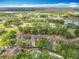 Aerial view of homes and a pool nestled among the trees near a golf course community at 602 Camino Real Blvd # 602, Howey In The Hills, FL 34737
