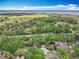 Aerial view of property highlighting its pool and surrounding landscape near a large body of water at 602 Camino Real Blvd # 602, Howey In The Hills, FL 34737