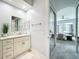 Bathroom with vanity, marble countertop, and framed mirror, next to an arched doorway to the bedroom at 602 Camino Real Blvd # 602, Howey In The Hills, FL 34737