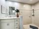 Bathroom featuring a vanity with modern fixtures and a tiled walk-in shower at 602 Camino Real Blvd # 602, Howey In The Hills, FL 34737