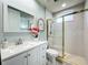 Bright bathroom features a vanity with marble countertops, a walk-in shower, and gold colored hardware at 602 Camino Real Blvd # 602, Howey In The Hills, FL 34737