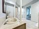 Elegant bathroom featuring a soaking tub with tile surround, decorative pillars, and views into other rooms at 602 Camino Real Blvd # 602, Howey In The Hills, FL 34737