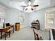 This bedroom has carpeted floors, a ceiling fan, and a decorative piano on the right side of the room at 602 Camino Real Blvd # 602, Howey In The Hills, FL 34737