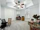 Bedroom featuring carpeted floors, tray ceiling with fan, and a large closet with plenty of storage space at 602 Camino Real Blvd # 602, Howey In The Hills, FL 34737