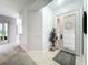 Bright entryway featuring tile flooring, a decorative front door, and a large potted plant creating a welcoming ambiance at 602 Camino Real Blvd # 602, Howey In The Hills, FL 34737