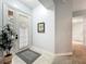 Bright foyer with neutral tile flooring, decorative painting, and a view of the hallway at 602 Camino Real Blvd # 602, Howey In The Hills, FL 34737