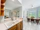 Bright kitchen view showcasing the sink, cabinets, breakfast nook, and golf course view at 602 Camino Real Blvd # 602, Howey In The Hills, FL 34737