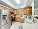 Well-equipped kitchen featuring stainless steel appliances and ample wood cabinetry at 602 Camino Real Blvd # 602, Howey In The Hills, FL 34737