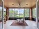 Relaxing enclosed lanai with golf course views, ceiling fan and a comfortable lounge chair at 602 Camino Real Blvd # 602, Howey In The Hills, FL 34737