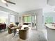 Living room featuring chairs, a table, and access to a bedroom and screened patio at 602 Camino Real Blvd # 602, Howey In The Hills, FL 34737