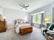 Bright bedroom with a large window, plush carpeting, and a neutral color scheme creating a relaxing retreat at 602 Camino Real Blvd # 602, Howey In The Hills, FL 34737