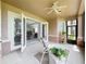 Charming covered patio with outdoor seating and open access to the living area through elegant French doors at 602 Camino Real Blvd # 602, Howey In The Hills, FL 34737
