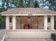 View of Wayne's Pool facility showing changing rooms with a terracotta tile roof and neutral exterior at 602 Camino Real Blvd # 602, Howey In The Hills, FL 34737