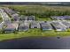 A high angle aerial view of a neighborhood with lake and green spaces at 6308 Mossy Oak Rd, St Cloud, FL 34771