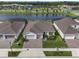 Stunning aerial view of a single-Gathering home with manicured lawn and paver driveway, close to community amenities and lake at 6308 Mossy Oak Rd, St Cloud, FL 34771