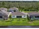 Aerial view of rear of several homes with screened in pools, back yards, and a lake at 6308 Mossy Oak Rd, St Cloud, FL 34771