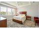 This bedroom features a tray ceiling, plantation shutters, neutral paint, and wood-look flooring at 6308 Mossy Oak Rd, St Cloud, FL 34771