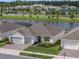Stunning exterior view of home with lush landscaping and a serene water view at 6308 Mossy Oak Rd, St Cloud, FL 34771