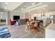 Open-concept living space features a modern kitchen, dining area, and comfortable seating at 6308 Mossy Oak Rd, St Cloud, FL 34771