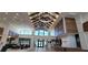 Stunning lobby with soaring ceilings, wood beams, modern chandeliers, and a welcoming reception area at the Hammock Club at 6308 Mossy Oak Rd, St Cloud, FL 34771