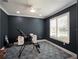 This office has a ceiling fan, plantation shutters, and a blue floral carpet at 6308 Mossy Oak Rd, St Cloud, FL 34771