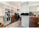 A large walk-in closet is complete with custom shelving and a variety of storage options at 6308 Mossy Oak Rd, St Cloud, FL 34771