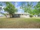 Backyard of home showing screened in lanai at 74 Stone Haven Ct, Leesburg, FL 34788