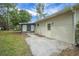 Back of the house with screened in lanai and concrete pad for outdoor enjoyment at 74 Stone Haven Ct, Leesburg, FL 34788