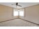 Bright bedroom offering carpet floors, ceiling fan, and neutral paint at 74 Stone Haven Ct, Leesburg, FL 34788