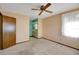 Comfortable bedroom with carpet floors, ceiling fan, and ensuite bathroom access at 74 Stone Haven Ct, Leesburg, FL 34788