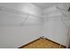 Large closet with white shelving and wood-look vinyl flooring at 74 Stone Haven Ct, Leesburg, FL 34788