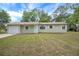 Charming single-story home featuring an attached garage and well-maintained front lawn at 74 Stone Haven Ct, Leesburg, FL 34788
