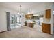 Bright kitchen with wooden cabinets open to dining area and view of sunroom, maximizing space at 74 Stone Haven Ct, Leesburg, FL 34788