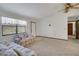 Bright living room features comfortable furniture and a large window at 74 Stone Haven Ct, Leesburg, FL 34788