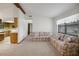 Open living area with kitchen view, beamed ceilings, and comfortable seating at 74 Stone Haven Ct, Leesburg, FL 34788