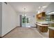 Bright room with a bar top overlooking the kitchen and sliding doors leading to the lanai at 74 Stone Haven Ct, Leesburg, FL 34788