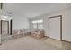 Bright living room features carpet floors, neutral walls, and large front window at 74 Stone Haven Ct, Leesburg, FL 34788