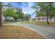 Charming single-story home featuring an attached garage, mature trees and a well-maintained lawn in a quiet neighborhood at 74 Stone Haven Ct, Leesburg, FL 34788