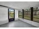 Bright sunroom featuring neutral walls, large windows, and access to the backyard at 74 Stone Haven Ct, Leesburg, FL 34788